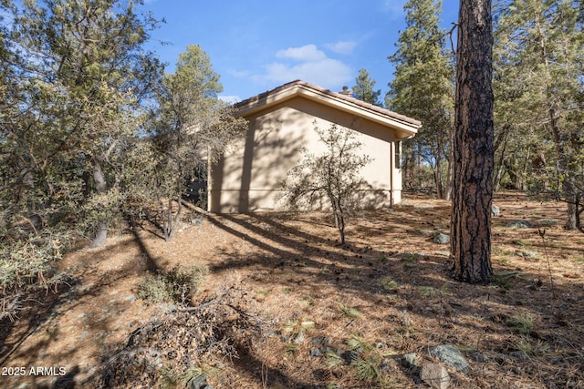 view of side of home featuring stucco siding