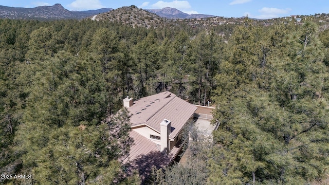 aerial view featuring a mountain view and a view of trees