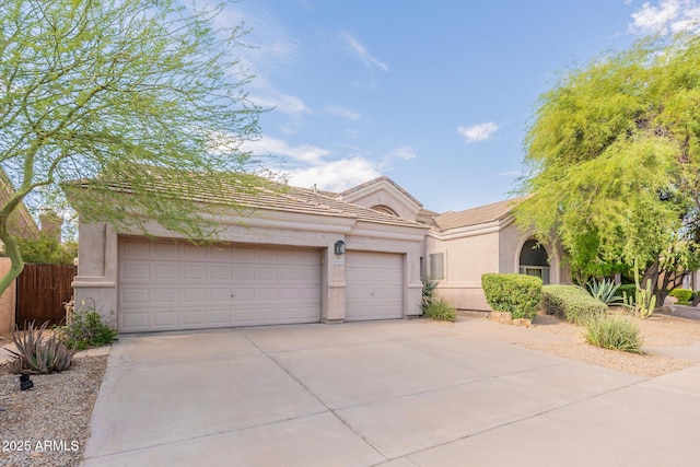 9678 E Voltaire Dr, Scottsdale, AZ 85260 - view of front of house with driveway, a tiled roof, a garage, and stucco siding