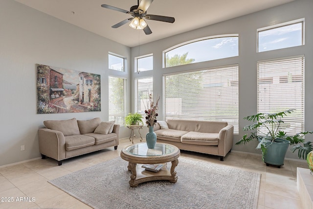 9678 E Voltaire Dr, Scottsdale, AZ 85260 - living room with light tile patterned floors, a ceiling fan, baseboards, and a towering ceiling