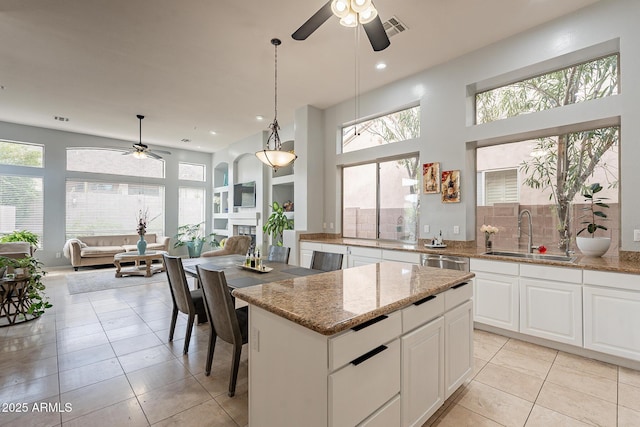 9678 E Voltaire Dr, Scottsdale, AZ 85260 - kitchen with a sink, a ceiling fan, stainless steel dishwasher, light tile patterned floors, and recessed lighting