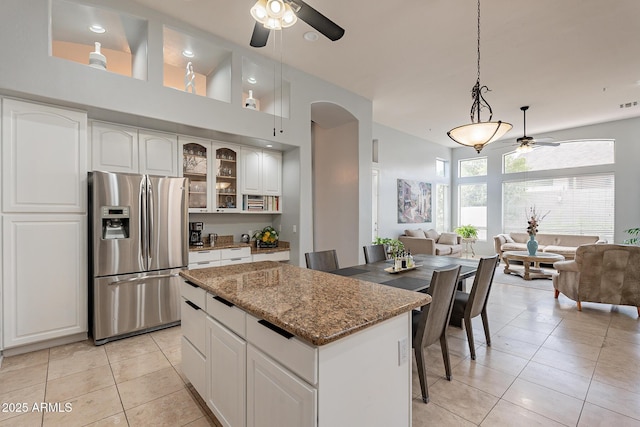 9678 E Voltaire Dr, Scottsdale, AZ 85260 - kitchen featuring stainless steel fridge, ceiling fan, open floor plan, and light tile patterned flooring