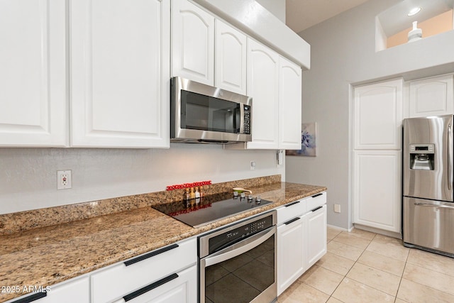 9678 E Voltaire Dr, Scottsdale, AZ 85260 - kitchen with stainless steel appliances, light stone counters, white cabinetry, light tile patterned floors, and baseboards