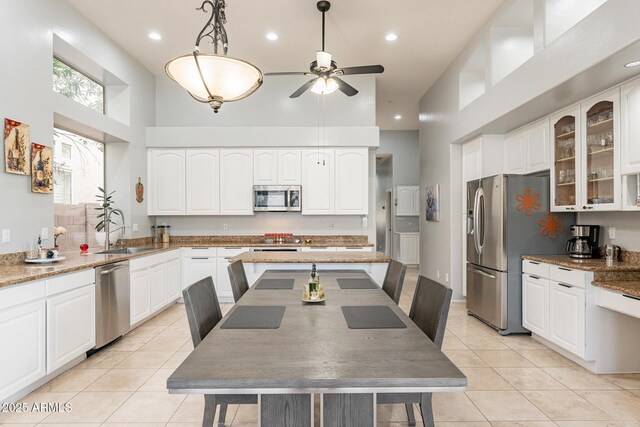 9678 E Voltaire Dr, Scottsdale, AZ 85260 - kitchen featuring appliances with stainless steel finishes, a sink, a high ceiling, a ceiling fan, and light tile patterned flooring