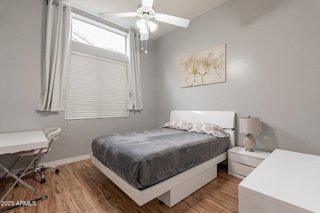 9678 E Voltaire Dr, Scottsdale, AZ 85260 - bedroom with light wood-type flooring, baseboards, and a ceiling fan