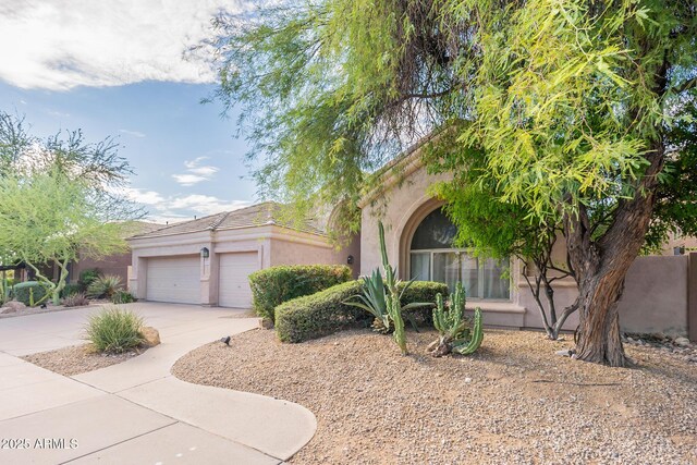 9678 E Voltaire Dr, Scottsdale, AZ 85260 - view of front of house featuring stucco siding, driveway, and an attached garage