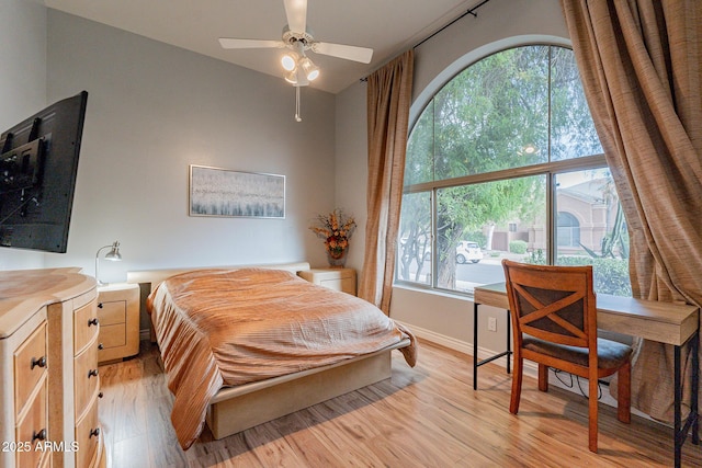 9678 E Voltaire Dr, Scottsdale, AZ 85260 - bedroom with multiple windows, light wood-type flooring, lofted ceiling, and baseboards