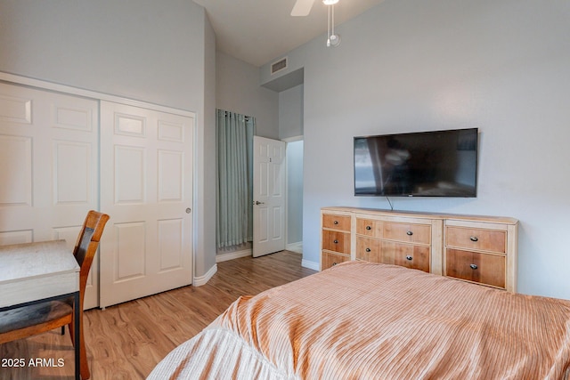 9678 E Voltaire Dr, Scottsdale, AZ 85260 - bedroom with wood finished floors, a closet, baseboards, a ceiling fan, and a towering ceiling
