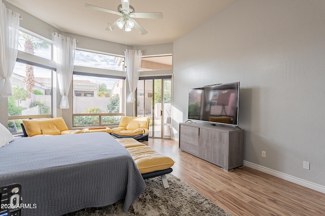 9678 E Voltaire Dr, Scottsdale, AZ 85260 - bedroom with multiple windows, light wood-style floors, baseboards, and a ceiling fan