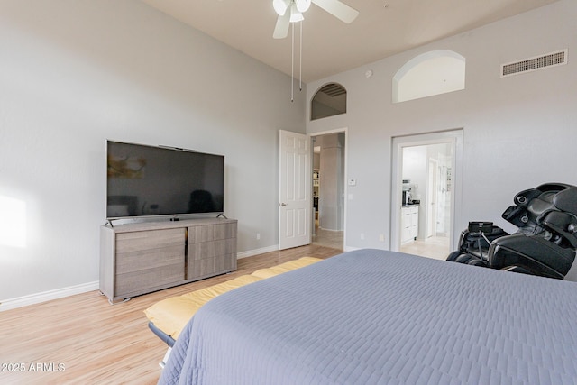 9678 E Voltaire Dr, Scottsdale, AZ 85260 - bedroom featuring light wood-style flooring, baseboards, a high ceiling, and ceiling fan