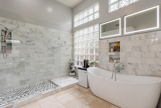9678 E Voltaire Dr, Scottsdale, AZ 85260 - full bath with tile walls, a soaking tub, a walk in shower, and tile patterned flooring