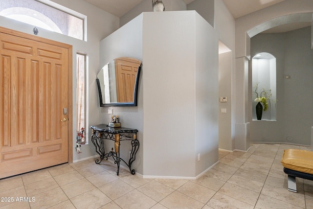 9678 E Voltaire Dr, Scottsdale, AZ 85260 - foyer entrance with arched walkways, light tile patterned floors, and baseboards