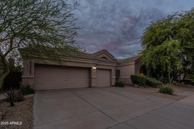 9678 E Voltaire Dr, Scottsdale, AZ 85260 - view of front of home with driveway, a garage, a tiled roof, and stucco siding