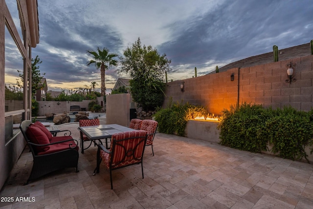 9678 E Voltaire Dr, Scottsdale, AZ 85260 - patio terrace at dusk featuring a patio area, a fenced backyard, and outdoor dining area