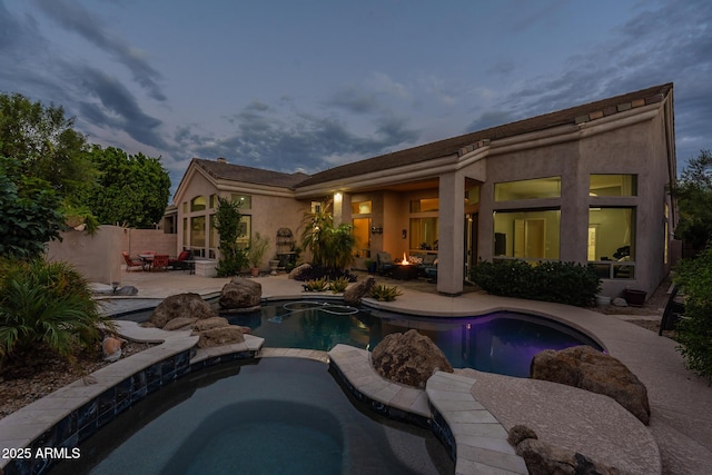 9678 E Voltaire Dr, Scottsdale, AZ 85260 - back of property featuring a patio area, a pool with connected hot tub, and stucco siding