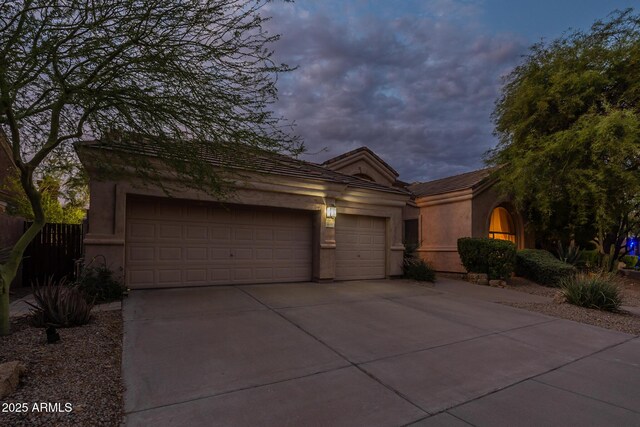 9678 E Voltaire Dr, Scottsdale, AZ 85260 - view of front of property featuring an attached garage, concrete driveway, stucco siding, and a tile roof