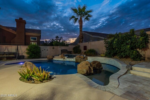 9678 E Voltaire Dr, Scottsdale, AZ 85260 - pool at dusk with a fenced backyard, a hot tub, and a patio