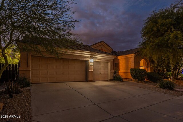 9678 E Voltaire Dr, Scottsdale, AZ 85260 - view of front of home with stucco siding, driveway, an attached garage, and a tiled roof