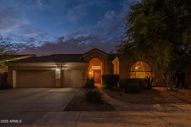 9678 E Voltaire Dr, Scottsdale, AZ 85260 - view of front of house featuring stucco siding, an attached garage, and driveway