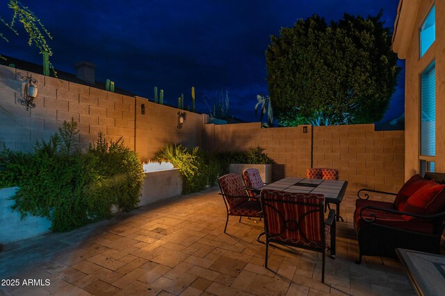 9678 E Voltaire Dr, Scottsdale, AZ 85260 - patio at twilight featuring a patio, a fenced backyard, and outdoor dining space
