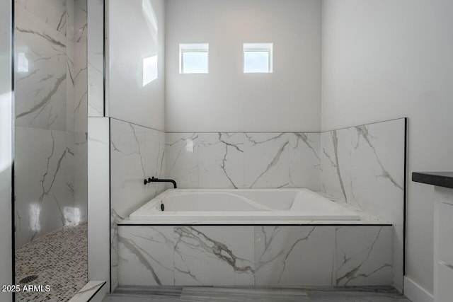 bathroom with tiled tub