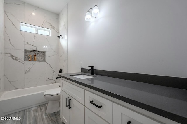 full bathroom with tiled shower / bath, vanity, toilet, and wood-type flooring