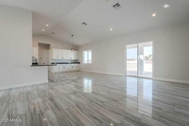 unfurnished living room featuring lofted ceiling