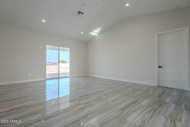 unfurnished room with vaulted ceiling