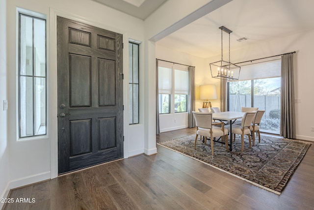 dining area featuring dark hardwood / wood-style flooring and a notable chandelier