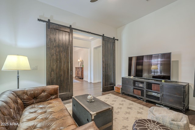 living room featuring a barn door and hardwood / wood-style floors