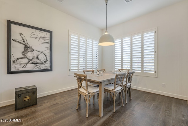 dining room with a healthy amount of sunlight and dark hardwood / wood-style flooring