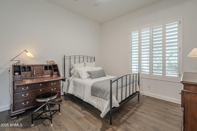 bedroom with dark hardwood / wood-style floors and ceiling fan