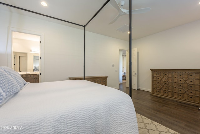 bedroom featuring connected bathroom, dark hardwood / wood-style floors, and ceiling fan