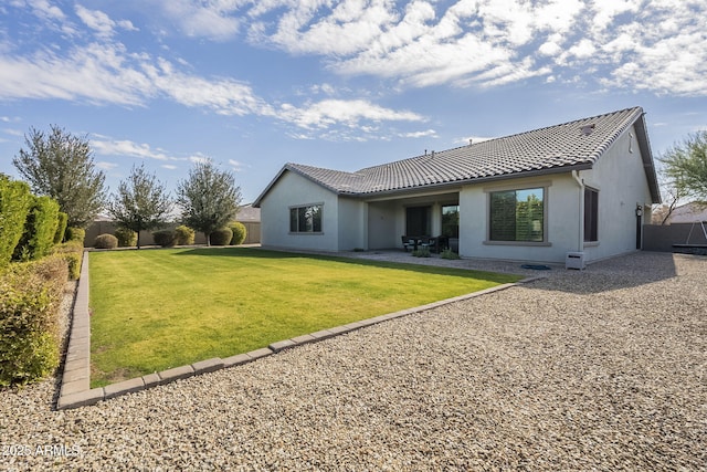 back of property featuring a yard and a patio area