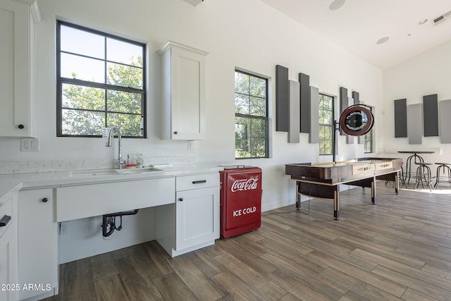 kitchen featuring white cabinetry, dark hardwood / wood-style flooring, and sink