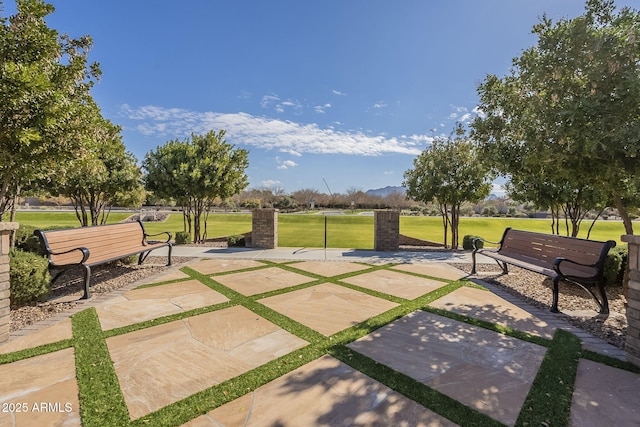 view of community featuring a lawn and a patio area