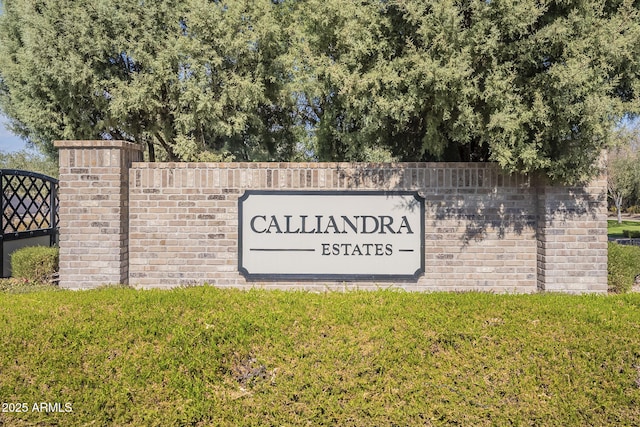 community / neighborhood sign with a lawn