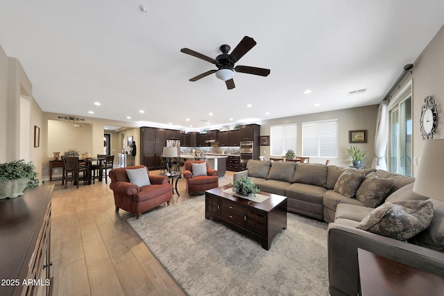 3359 E Penedes Dr, Gilbert, AZ 85298 - living area featuring recessed lighting, a ceiling fan, and light wood-style floors