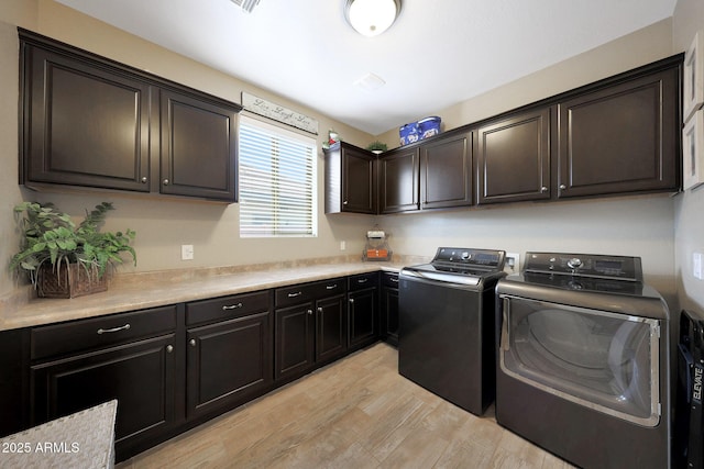 3359 E Penedes Dr, Gilbert, AZ 85298 - washroom with cabinet space, washer and clothes dryer, and light wood finished floors
