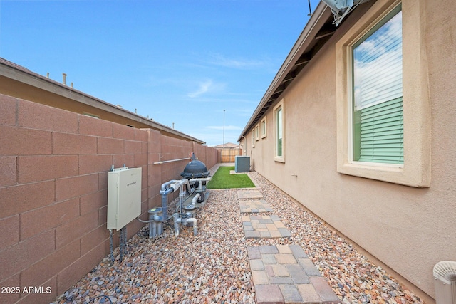 3359 E Penedes Dr, Gilbert, AZ 85298 - view of side of property with a fenced backyard, stucco siding, and central AC