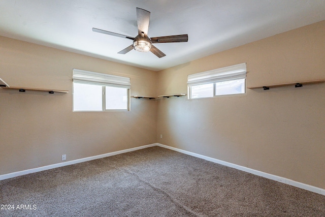 empty room featuring a ceiling fan, carpet, and baseboards