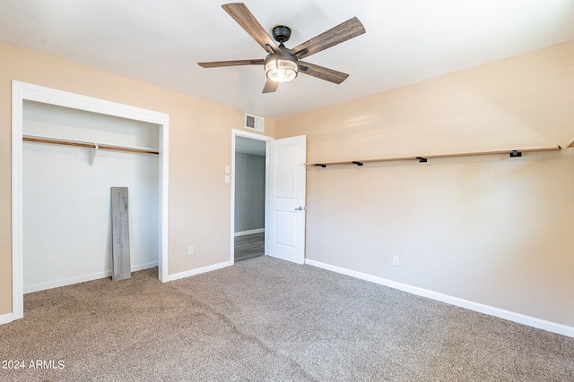 unfurnished bedroom featuring baseboards, visible vents, ceiling fan, carpet flooring, and a closet