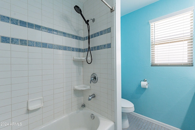 bathroom featuring toilet, shower / tub combination, baseboards, and tile patterned floors