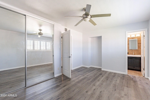 unfurnished bedroom featuring ceiling fan, a closet, wood finished floors, and baseboards