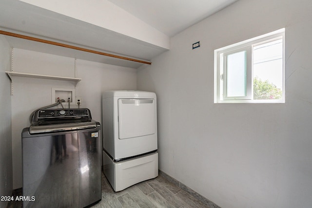 laundry area with laundry area, light wood-style floors, and washer and dryer