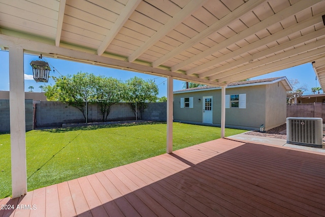 wooden terrace with a fenced backyard, a lawn, and central air condition unit