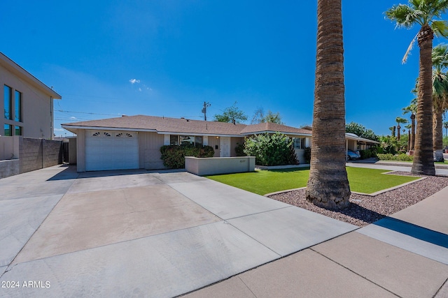 ranch-style house with a front yard and a garage