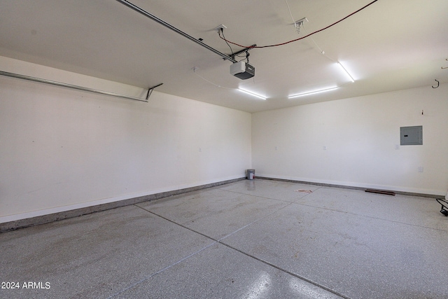 garage featuring baseboards, electric panel, and a garage door opener