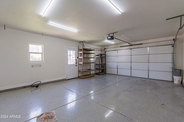 garage with a garage door opener and baseboards