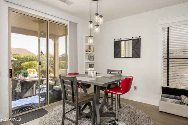 dining room featuring baseboards and wood finished floors